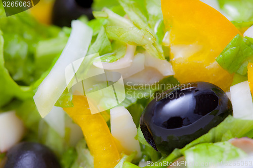 Image of Assorted salad of green leaf lettuce with squid and black olives