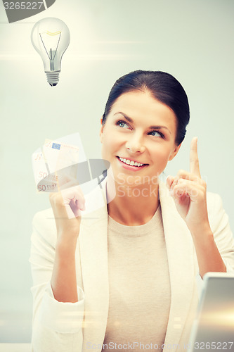 Image of woman with cash euro money and light bulb