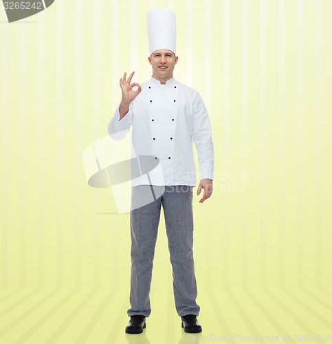 Image of happy male chef cook showing ok sign