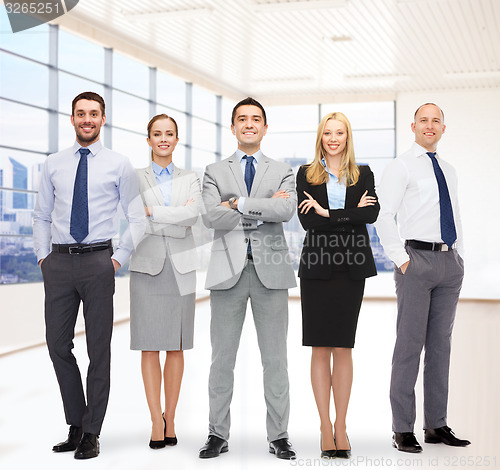 Image of group of smiling businessmen over office room