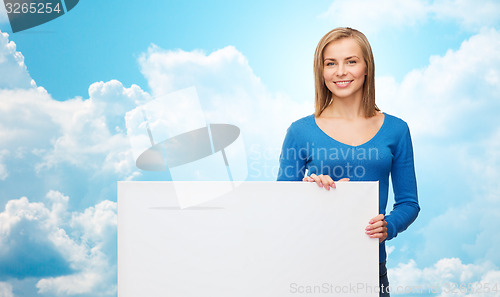 Image of smiling young woman with blank white board