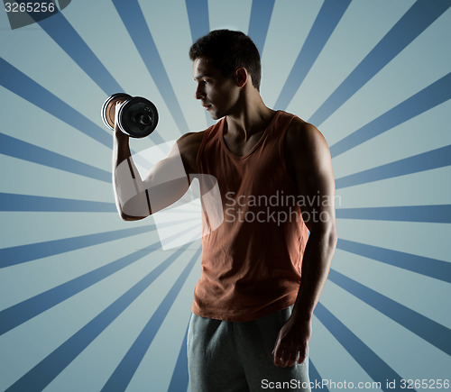 Image of young man with dumbbell flexing biceps