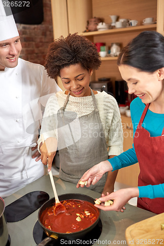 Image of happy women and chef cook cooking in kitchen