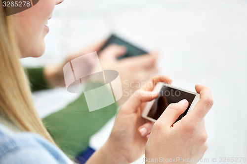 Image of close up of female hands with smartphone