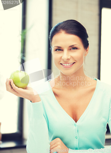 Image of lovely housewife with green apple