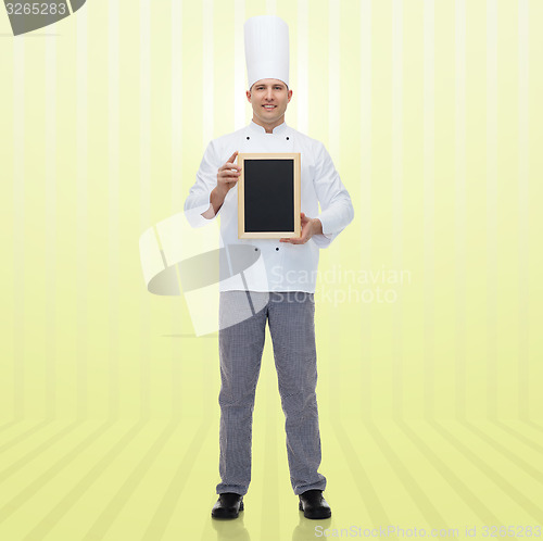 Image of happy male chef cook holding blank menu board