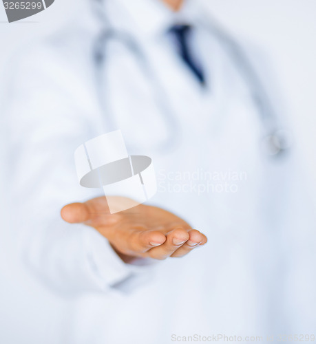 Image of male doctor holding something in his hand