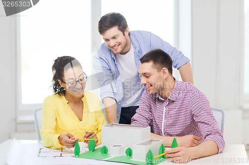 Image of smiling architects working in office