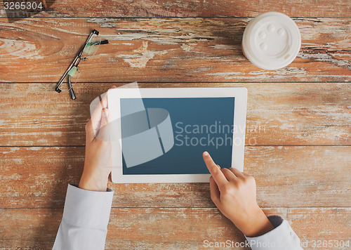 Image of close up of hands with tablet pc and coffee