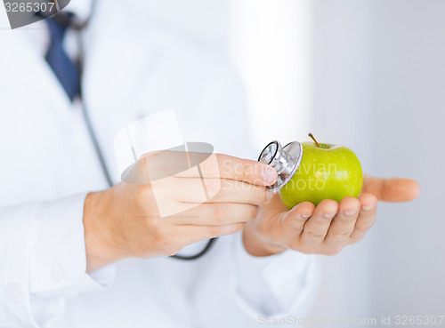 Image of male doctor with green apple and stethoscope