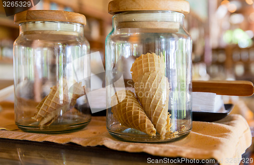 Image of close up of jars with waffle cones at restaurant