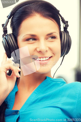 Image of happy teenage girl in big headphones