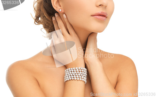 Image of beautiful woman with pearl earrings and bracelet