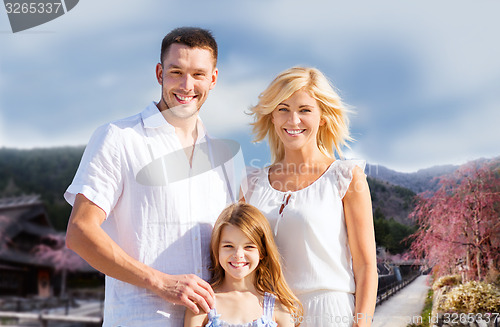 Image of happy family over hills background