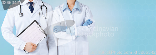 Image of nurse and male doctor holding cardiogram