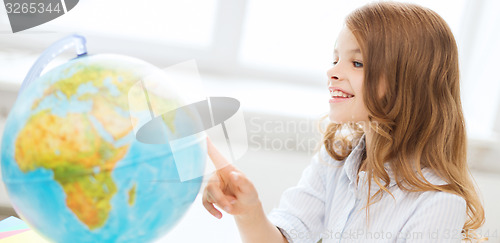 Image of smiling student girl with globe at school