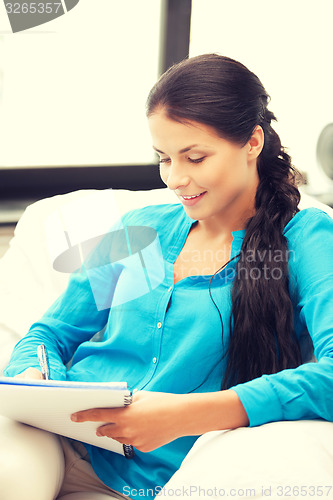 Image of happy woman with big notepad