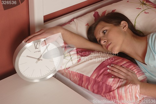 Image of Young woman with clock