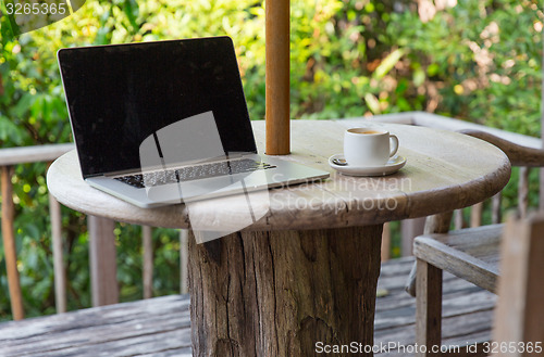 Image of close up of laptop computer on table at hotel