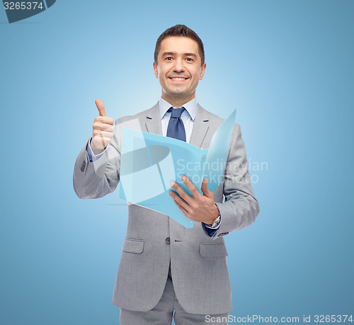 Image of happy businessman with folder showing thumbs up