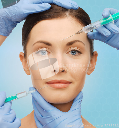 Image of woman face and surgeon hands with syringes