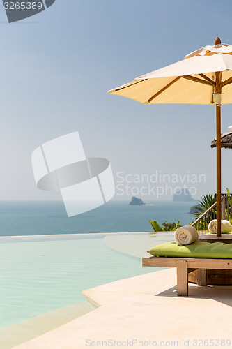 Image of view from infinity edge pool with parasol to sea