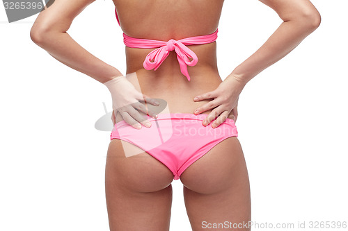 Image of close up of young woman buttocks in pink bikini