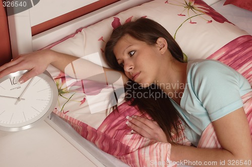 Image of Young woman with clock