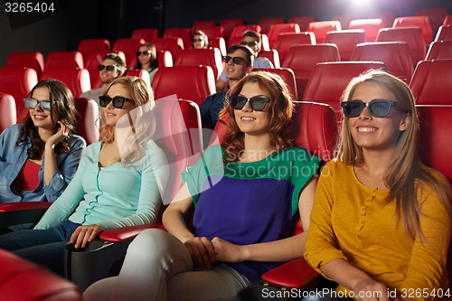 Image of happy friends watching movie in 3d theater