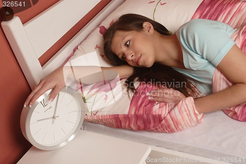 Image of Young woman with clock