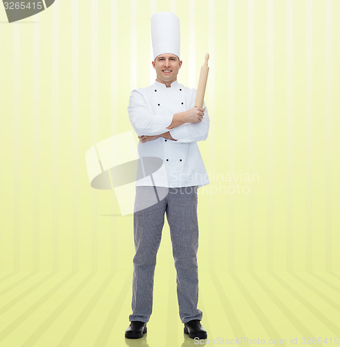 Image of happy male chef cook holding rolling pin