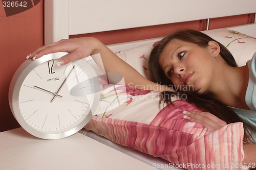 Image of Young woman with clock