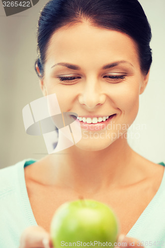 Image of lovely housewife with green apple