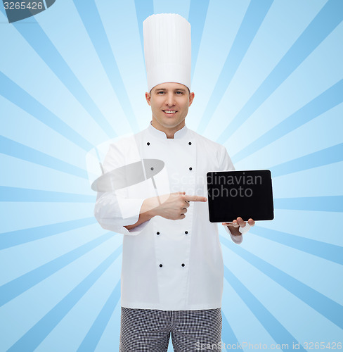 Image of happy male chef cook showing with tablet pc