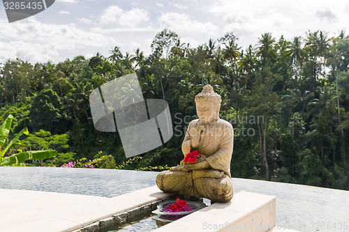 Image of infinity edge pool with buddha statue