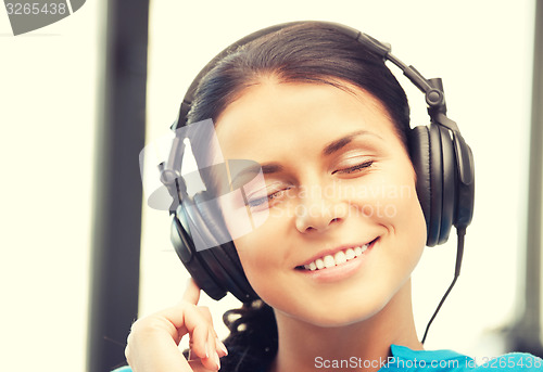 Image of happy teenage girl in big headphones