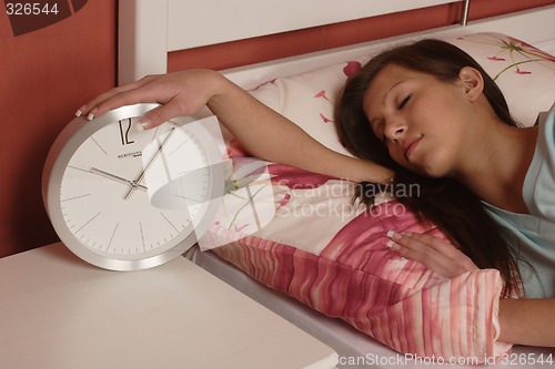 Image of Young woman with clock