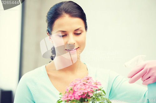 Image of lovely housewife with flower