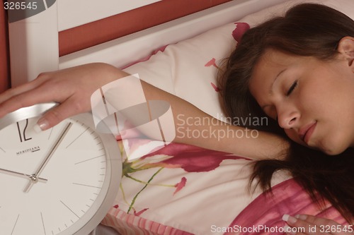 Image of Young woman with clock