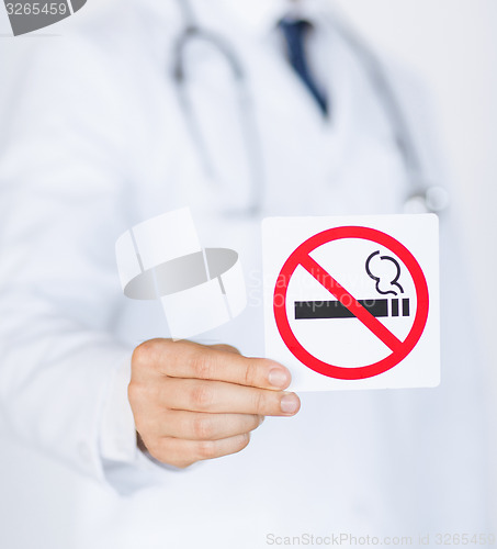 Image of male doctor holding no smoking sign