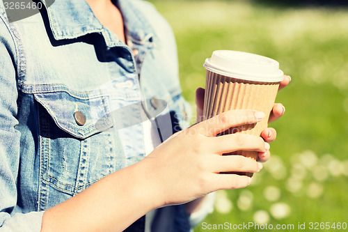 Image of close up of young girl with coffee cup outdoors
