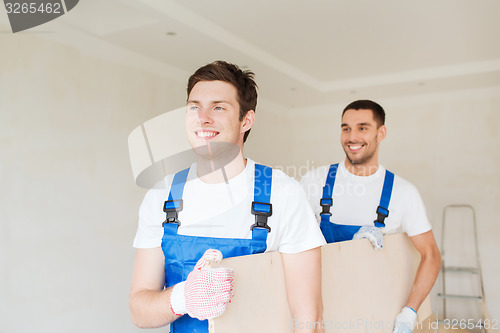 Image of group of builders with wooden boards