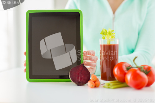 Image of close up of woman with tablet pc and vegetables