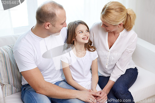 Image of happy parents with little daughter at home