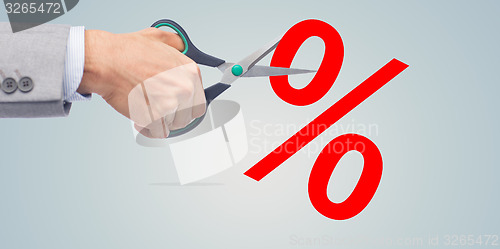 Image of close up of businessman with scissors and percents