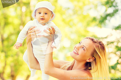 Image of happy mother with little baby in park