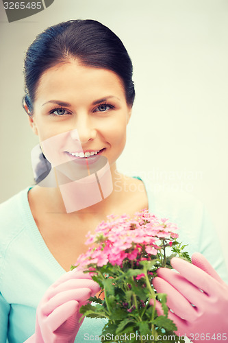 Image of lovely housewife with flower