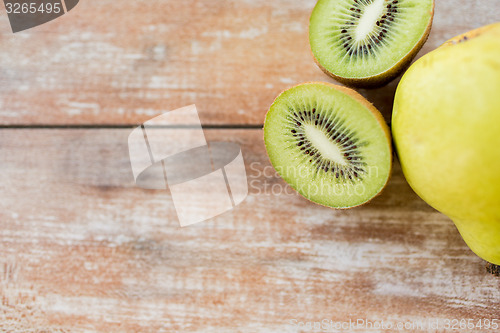 Image of close up of ripe kiwi and pear on table