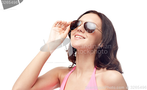 Image of happy woman in sunglasses and swimsuit