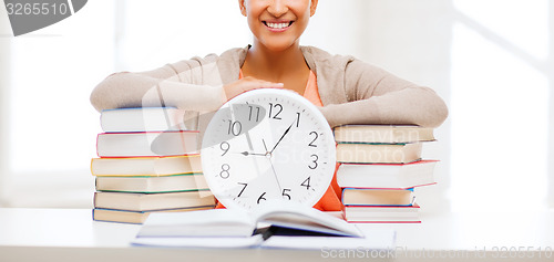 Image of attractive woman with white clock